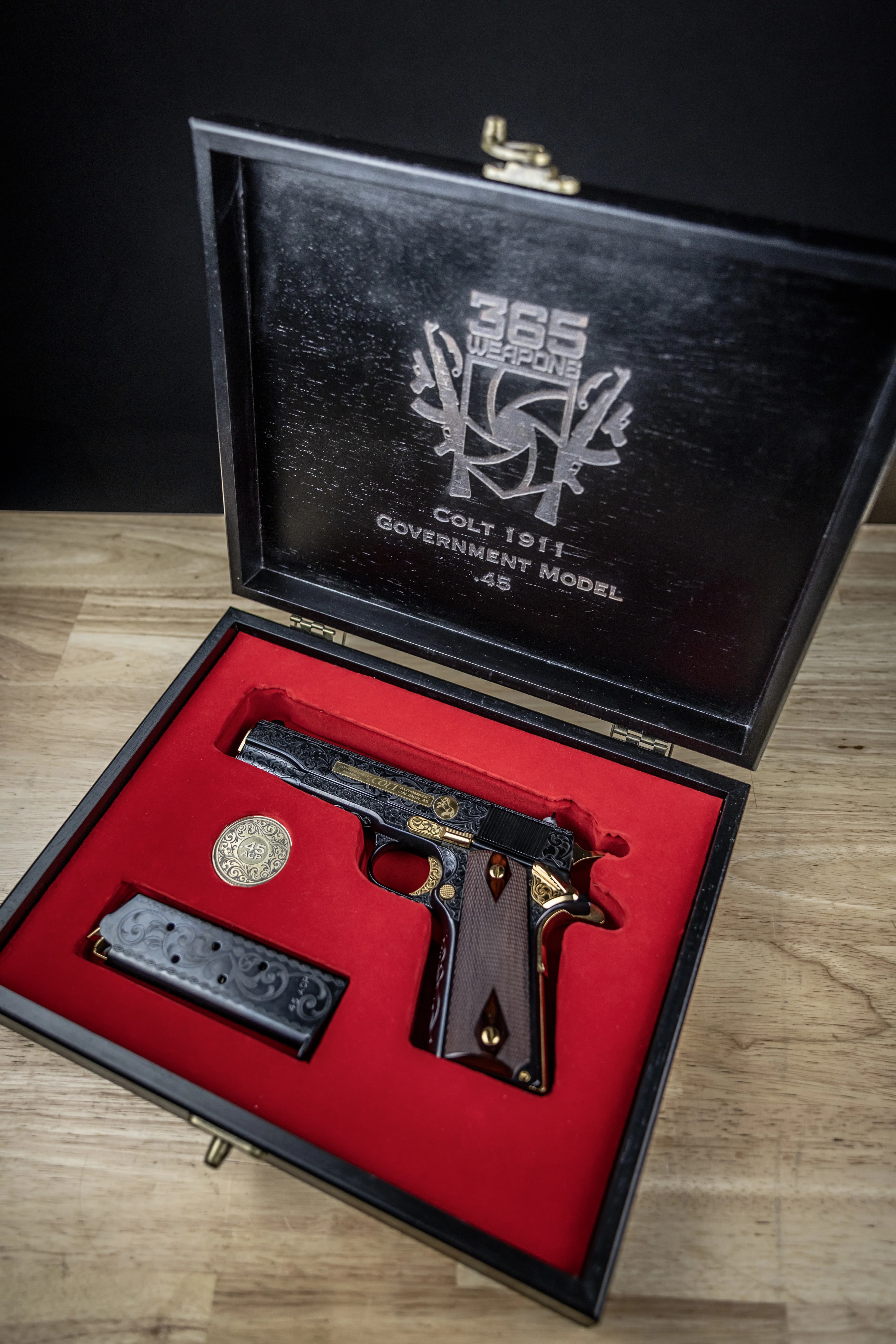 Engraved 1911 slide top view with cross detail and gold barrel