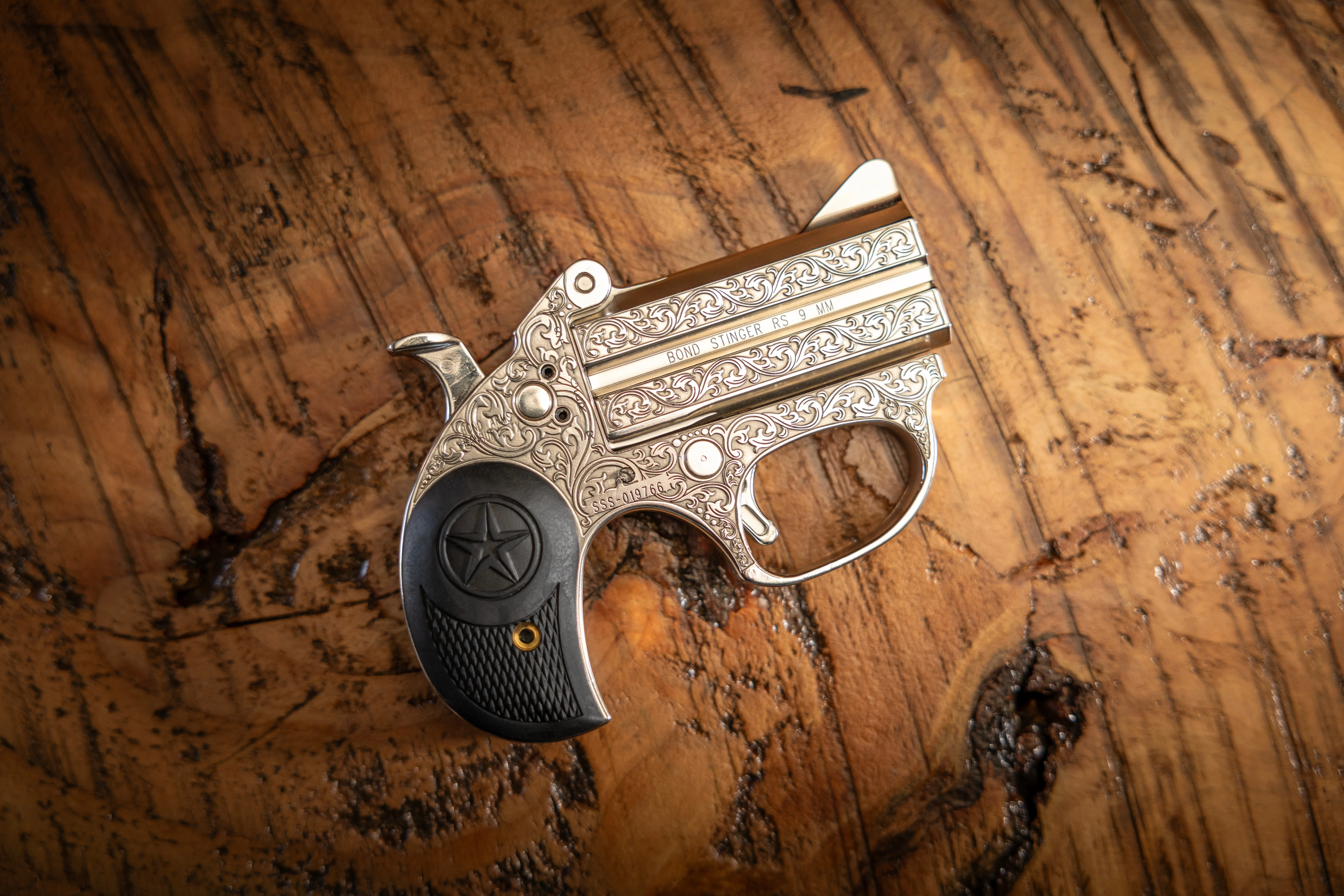 Engraved Bond Arms derringer on wood